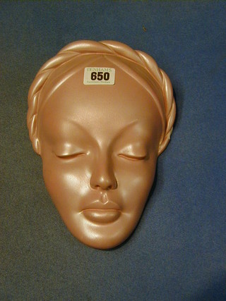 A pink glazed plaster wall mask in the form of  a lady (chipped) the reverse marked Gleonid 10"