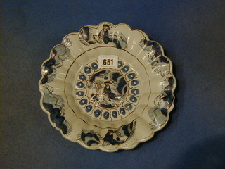 An Oriental pottery blue and white circular dish with lobed decoration, decorated a seated figure 9"