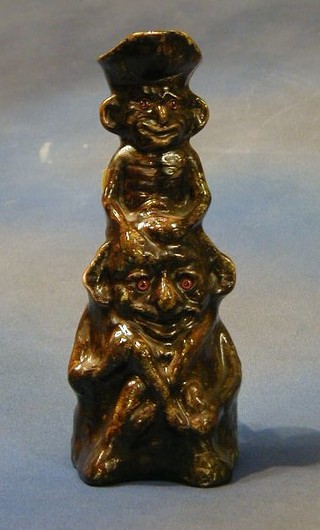 A 19th Century treacle glazed pottery Toby jug in the form of 2 seated Pixies 10" (spout f)