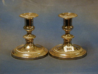 A pair of silver plated stub shaped candlesticks