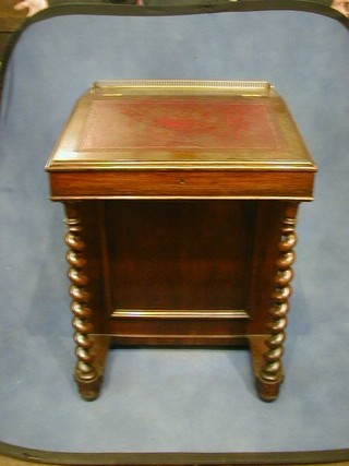 A William IV rosewood Davenport with pierced brass three- quarter gallery, inkwell and tooled leather writing surface, the 4 drawer pedestal raised on spiral turned supports,  24"