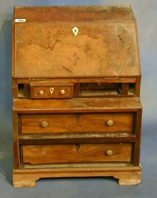 A Georgian style figured walnutwood bureau with fall front revealing a well fitted interior above 2 short and 2 long drawers, raised on bracket feet (in barn condition) 15"