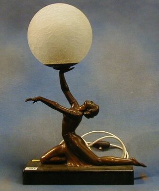 A 1930's Art Deco bronze and marble table lamp in the form of a semi-clad lady supporting a frosted glass Globe and raised on a marble base 20"
