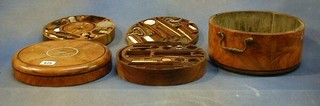 A gentleman's fine quality Georgian circular inlaid walnutwood travelling set with brass drop handles to the sides, the interior fitted a zinc bowl, 3 compartments fitted shaving brush, eye bath, shaving bowl, boot pulls etc (some items missing)