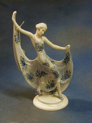 An Art Deco Continental porcelain figure of a dancing lady raised on a circular base 13" 