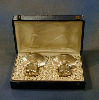 A pair of fine quality 19th Century French silver cups and saucers with engine turned decoration cased