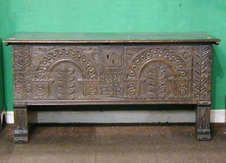 A 17th/18th Century carved oak coffer of plank construction with hinged lid 53"