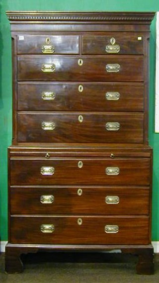 A Georgian mahogany chest of chest with moulded and dentil cornice the upper section fitted 2 short and 3 long drawers, the base fitted a brushing slide above 3 long drawers raised on bracket feet 40"