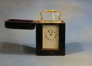 A 19th Century French 8 day striking carriage clock with enamelled dial and Roman numerals, contained in a gilt metal case 5" complete with leather carrying case