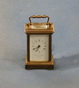 A Swiss 8 day miniature carriage timepiece with enamelled dial and Roman numerals contained in a gilt metal case by Matthew Norman of London 3"