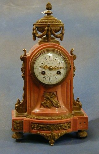 A  fine quality French 19th Century 8 day striking mantel clock with enamelled dial and Arabic numerals contained in an arched pink marble case with gilt ormolu mounts by Mangourd Freres