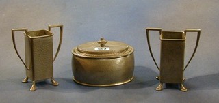 A Tudric oval  planished pewter caddy 5", the base marked 01566 and a pair of Civic pewter twin handled specimen vases bases marked 1549