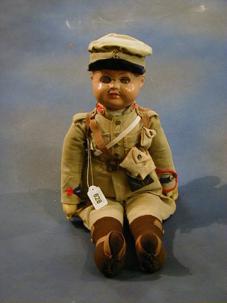 An English composition and fabric doll in soldier costume