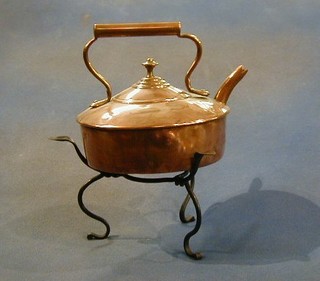 A 19th Century copper kettle raised on an iron stand