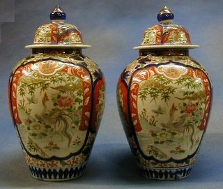 A pair of 19th Century Japanese Imari porcelain vases and covers 14"