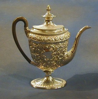 A George III oval shaped embossed silver coffee pot with acorn finial raised on a oval base London 1801 25 ozs