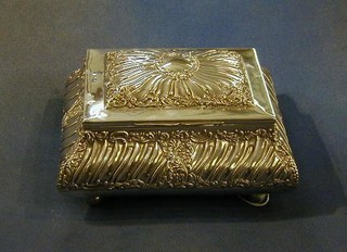An Edwardian embossed silver cigarette box with hinged lid raised on 4 bun supports London 1898 by the Goldsmiths & Silversmiths Co. 8" (some holes to the lid)
