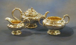 A William IV 3 piece silver tea service of melon form comprising teapot, twin handled sugar bowl and cream jug, London 1836 and 1855, 42 ozs