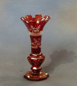 A 19th Century Bohemian red overlay glass vase decorated swags raised on an octagonal base 8" (some chips)