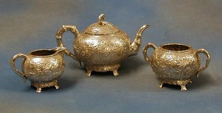 An Eastern embossed silver 3 piece tea service comprising teapot, twin handled sugar bowl and cream jug with bamboo decoration, 31 ozs