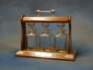 An oak and silver plated 3 bottle tantalus