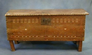 A 17th Century oak coffer of plank construction with iron lock and arcaded decoration, the hinged lid revealing a candle box 44"