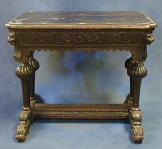 A Victorian carved oak centre table raised on 4 turned column supports united by a carved X framed stretcher 34"