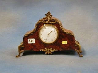 A French 19th/20th Century 8 day bedroom timepiece with enamelled dial and Arabic numerals contained in an arched figured walnutwood case with gilt metal mounts