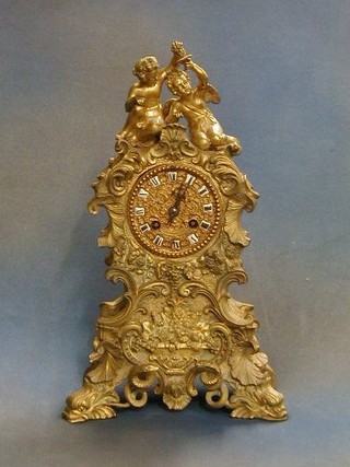 A French 8 day  striking mantel clock contained in a gilt ormolu case surmounted by 2 figures of kneeling cherubs (no pendulum, no bell)