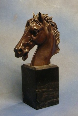 A bronze head and shoulders portrait bust of a horses head, on a black marble base 15"