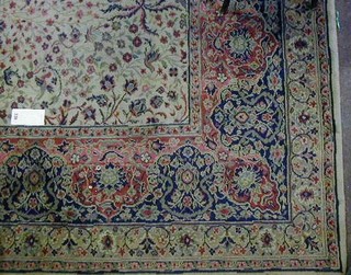A green ground and floral patterned Persian style carpet having a central medallion within multi-row borders 144" x 108"