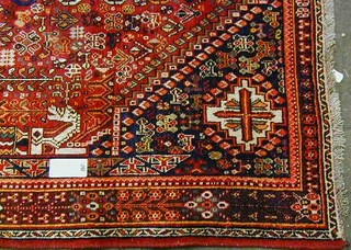 A contemporary red ground and floral pattern Persian carpet 97" x 61"