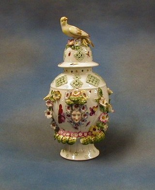 A 19th Century Sampson porcelain pierced urn and cover with floral encrusted decoration, the lid finial in the form of a seated bird 12"