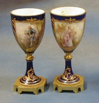 A fine pair of 19th Century Sevres porcelain goblets with panelled decoration decorated lady and gentleman, raised on square gilt ormolu bases 7"