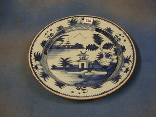 An antique Delft blue and white pottery bowl plate decorated temples and birds 13"