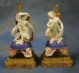 A pair of 19th Century biscuit porcelain figures depicting Education and Peace? converted for use as electric table lamps and raised on pierced gilt metal bases 16"