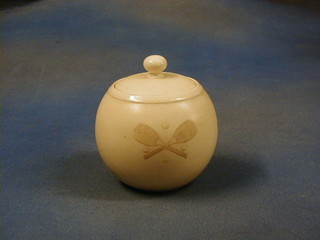 A MacIntyre circular pottery biscuit barrel decorated 2 crossed tennis rackets and 4 balls, the base marked MacIntyre Burslem England RD No. 296287