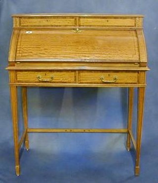 A 19th/20th Century inlaid and crossbanded satinwood cylinder bureau, fitted 2 drawers, the fall front revealing a well fitted interior above 2 short drawers raised on square tapering supports ending in spade feet 32"