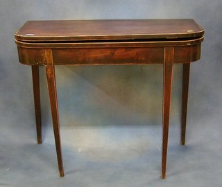 A Georgian mahogany tea table inlaid satinwood stringing, raised on square tapering supports 36"