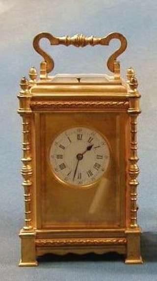 An 19th Century French half repeating carriage clock with 2" circular enamelled dial contained in an ornate gilt metal case 