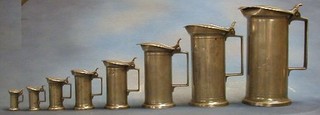 A set of 8 17th/18th Century Continental graduated lidded pewter jugs