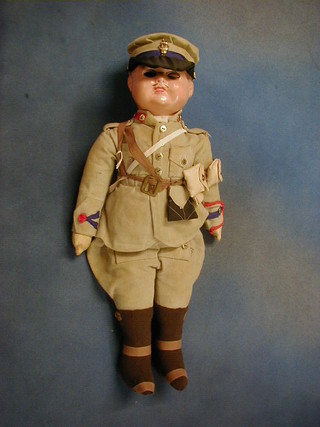 An English composition and fabric doll in soldier costume