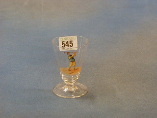 A small waisted glass decorated a golfer (chip to rim) 3 1/2"