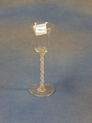 An 18th Century ale glass with bell shaped bowl and cotton twist stem (slight chip to bowl)
