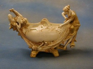 A Royal Vienna porcelain boat shaped vase supported by figures of maidens with tumbling children (chipped and r), the base marked Royal Vienna Wahliss and incised 380, 6"
