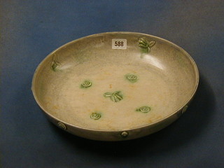 A circular green glazed Clarice Cliff shallow bowl, the base marked Clarice Cliff, 13" diam.