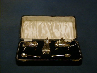 A silver plated 3 piece cruet set comprising mustard, salt and pepper, cased