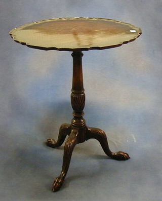 A 19th Century Chippendale style snap top wine table with pie crust edge, raised on pillar and tripod supports 23"