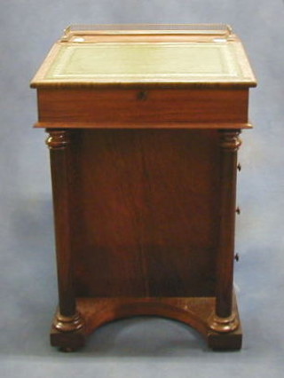 A Victorian rosewood Davenport desk with brass three-quarter gallery, the pedestal fitted an inkwell above 4 long drawers, raised on turned columns 20"