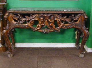 A Continental carved and pierced walnutwood console table decorated cherubs with black veined marble top 52"